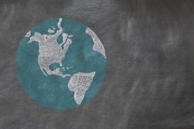 A hand drawn chalkboard shows multi-ratial people holding hands around the world to show care for the earth, peace, and unity.  Shown off centered for copy-space.